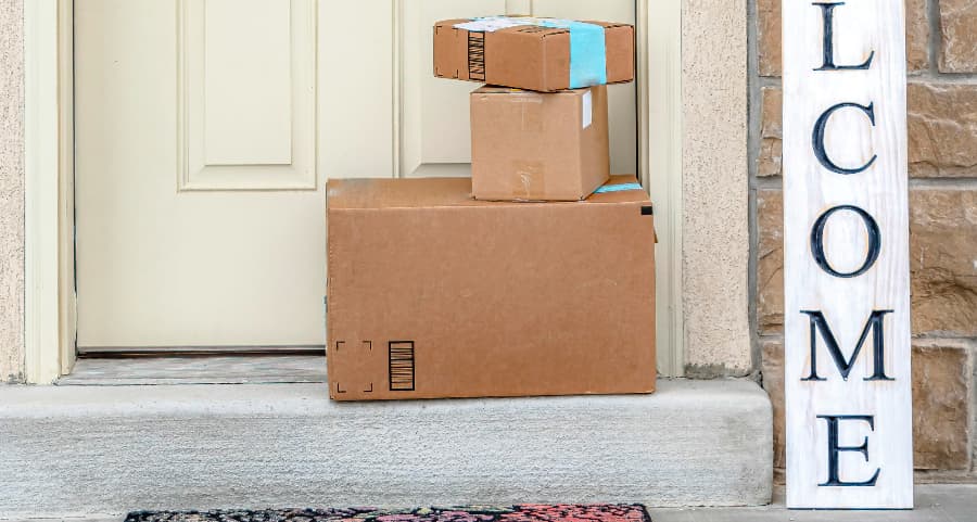 Deliveries on the front porch of a house with a welcome sign in Bloomington